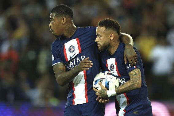 PSG's Presnel Kimpembe, left, and PSG's Neymar celebrate after scoring during the French League One soccer match between Paris Saint-Germain and Monaco at the Parc des Princes in Paris, France, Sunday, Aug. 28, 2022. (AP Photo/Aurelien Morissard)