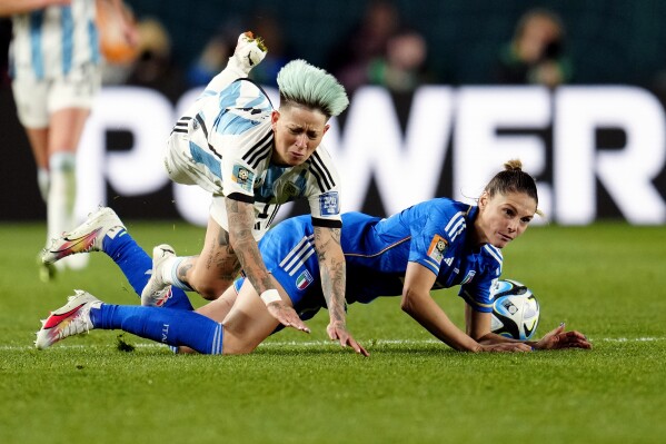 Argentina's Yamila Rodriguez, left, and Italy's Cecilia Salvai fall during the Women's World Cup Group G soccer match between Italy and Argentina at Eden Park in Auckland, New Zealand, Monday, July 24, 2023. (AP Photo/Abbie Parr)