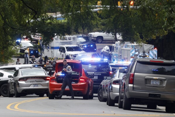 Law enforcement and first responders gather on South Street near the Bell Tower on the University of North Carolina at Chapel Hill campus in Chapel Hill, N.C., Monday, Aug. 28, 2023, after a report of an 