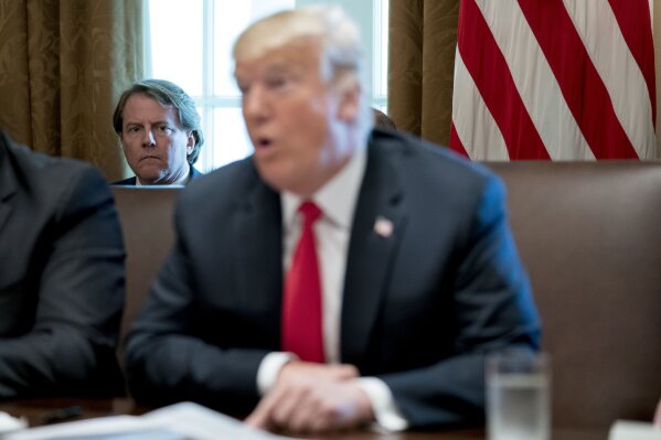 
              FILE- In this Aug. 16, 2018, file photo White House counsel Donald McGahn, left, listens as President Donald Trump speaks during a cabinet meeting in the Cabinet Room of the White House in Washington. Trump insisted Sunday, Aug. 19, that McGahn isn't "a John Dean type 'RAT,'" making reference to the Watergate-era White House attorney who turned on Richard Nixon. Trump, in a series of angry tweets, blasted a New York Times story reporting that McGahn has been cooperating extensively with the special counsel team investigating Russian election meddling and potential collusion with Trump's Republican campaign. (AP Photo/Andrew Harnik, File)
            