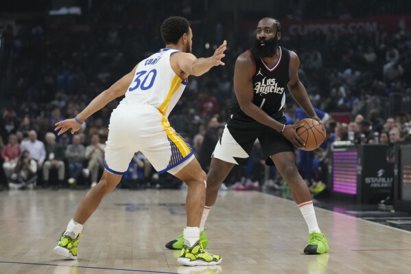 Golden State Warriors guard Stephen Curry (30) defends against Los Angeles Clippers guard James Harden (1) during the first half of an NBA basketball game in Los Angeles, Saturday, Dec. 2, 2023. (AP Photo/Ashley Landis)