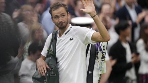 Russia's Daniil Medvedev leaves the court after losing to Spain's Carlos Alcaraz in their men's singles semifinal match on day twelve of the Wimbledon tennis championships in London, Friday, July 14, 2023. (AP Photo/Alberto Pezzali)