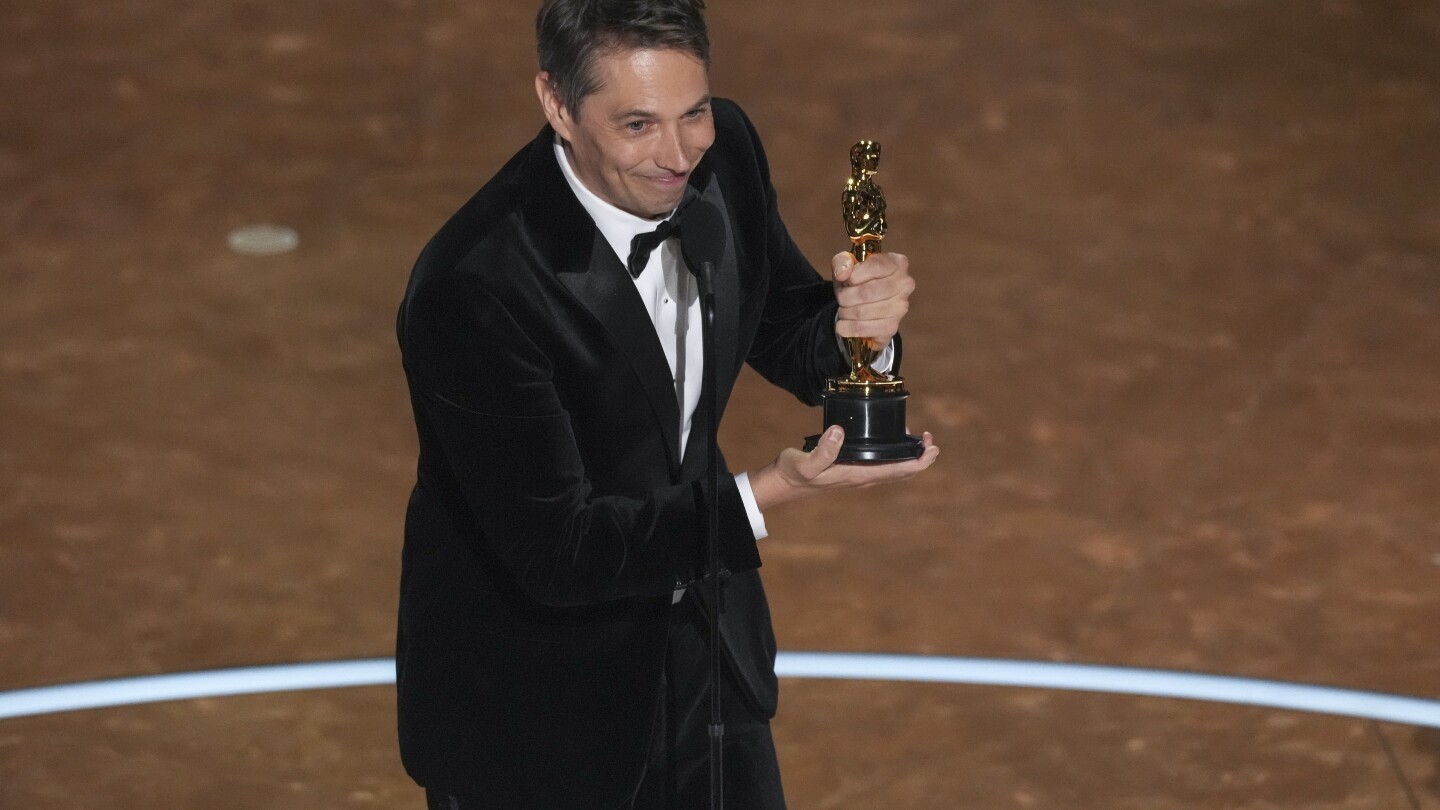 Sean Baker wins original screenplay Oscar for 'Anora.' 'Conclave' wins adapted screenplay trophy