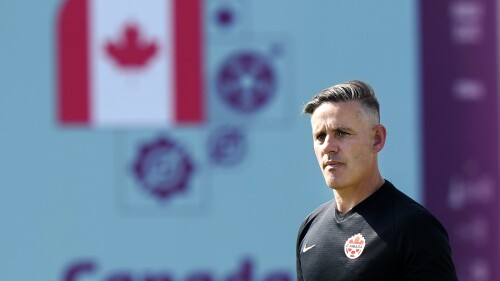 FILE- Canada head coach John Herdman watches his team during practice at the World Cup soccer tournament in Doha, Qatar, Nov. 28, 2022. Herdman challenged the Canada Soccer Association to increase resources ahead of the 2026 World Cup. “We've got to figure this out financially,” he said Sunday, June 18, 2023, after Canada's 2-0 loss to the United States in the CONCACAF Nations League final. Canada's men have not won a trophy since the 2000 CONCACAF Gold Cup. (Nathan Denette/The Canadian Press via AP, File)
