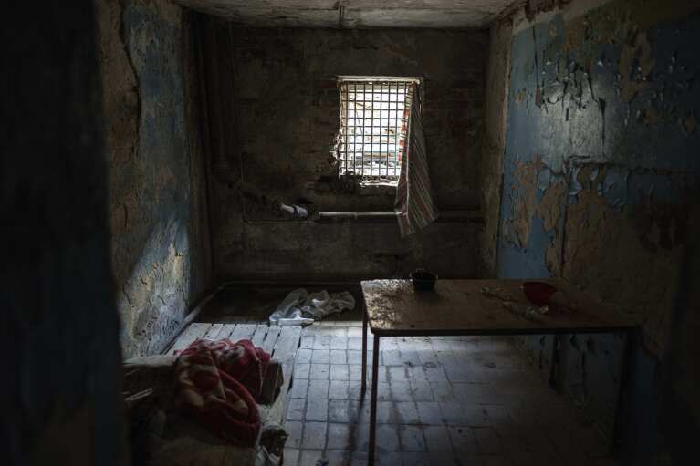 Bars cover a window of a room in a police department in Izium, Ukraine, Thursday, Sept. 22, 2022. Ukrainian civilians said they were held and tortured at this site by Russian soldiers. (AP Photo/Evgeniy Maloletka)