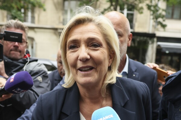 French far-right leader Marine Le Pen arrives at the National Rally party headquarters, Monday, June 10, 2024 in Paris. French President Emmanuel Macron dissolved the lower house of France's parliament in a surprise announcement sending voters back to the polls in the coming weeks to choose lawmakers, after his party was handed a humbling defeat by the far-right in the European elections Sunday. (AP Photo/Thomas Padilla)