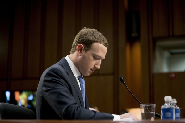 
              FILE- In this April 10, 2018, file photo Facebook CEO Mark Zuckerberg pauses while testifying before a joint hearing of the Commerce and Judiciary Committees on Capitol Hill in Washington about the use of Facebook data to target American voters in the 2016 election. The British Parliament has released some 250 pages worth of documents that show Facebook considered charging developers for data access. The documents show internal discussions about linking data to revenue. (AP Photo/Andrew Harnik, File)
            