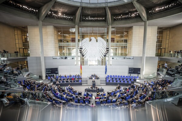Robert Habeck, Federal Minister for Economic Affairs and Climate Protection, speaks in the Bundestag. in Berlin, Friday Sept. 8, 2023. German lawmakers on Friday approved contentious legislation for the replacement of fossil-fuel heating systems, passing a major climate policy plan that prompted lengthy infighting in the governing coalition and helped push down its poll ratings. (Michael Kappeler/dpa via AP)