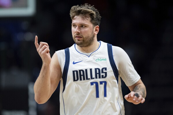 Dallas Mavericks guard Luka Doncic (77) looks on during the second half of an NBA basketball game against the Charlotte Hornets Tuesday, April 9, 2024, in Charlotte, N.C. (AP Photo/Jacob Kupferman)