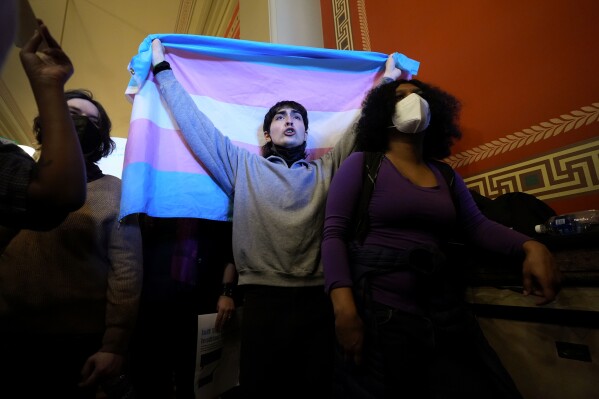 FILE - LGBTQ+ rights supporters rally in the hallway outside an Iowa House Judiciary subcommittee hearing, Wednesday, Jan. 31, 2024, at the Statehouse in Des Moines, Iowa. The rights of LGBTQ+ people continue to be in flux across the U.S. with a new flurry of developments. (AP Photo/Charlie Neibergall, File)