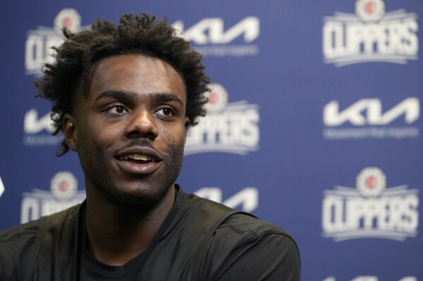 First-round draft pick Kobe Brown, selected 30th overall by Los Angeles Clippers, speaks at a news conference in Los Angeles on Saturday, July 1, 2023. (AP Photo/Damian Dovarganes)