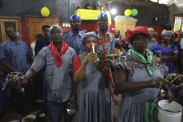 FILE - Vodou pilgrims attend a Mass marking the feast day of agriculture and work, in Port-au-Prince, Haiti, Wednesday, May 1, 2024. Amid the spiraling chaos, a growing number of Haitians are praying more or visiting Vodou priests known as “oungans” for urgent requests ranging from locating loved ones who were kidnapped to finding critical medication needed to keep someone alive. (Ǻ Photo/Odelyn Joseph, File)