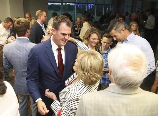 
              Gubernatorial candidate Kevin Stitt, left, greets supporters during a watch party in Jenks, Okla., Tuesday, Aug. 28, 2018. (Matt Barnard/Tulsa World via AP)
            