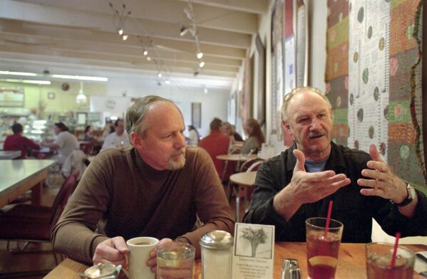 Gene Hackman, right, and long-time friend Daniel Lenihan, discuss their new book, "Wake of the Perdido Star," on Nov. 19, 1999, in Cloudclift Bakery, the cafe where they first dreamed up their adventure story, in Santa Fe, N.M. (AP Photo/Sarah Martone, File)