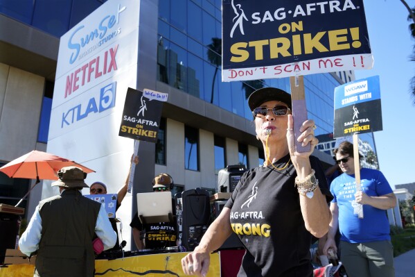 Striking SAG-AFTRA member Karen Brown participates in a picket line outside Netflix studios, Wednesday, Nov. 8, 2023, in Los Angeles. (AP Photo/Chris Pizzello)
