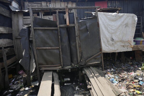A bathroom and toilets were Funmilayo Kotun, a malaria patient and others use in Makoko neighbourhood of Lagos, Nigeria, Saturday, April 20, 2024. (AP Photo/Sunday Alamba)