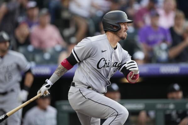 Chicago White Sox' Yasmani Grandal follows the flight of his double off Colorado Rockies starting pitcher German Marquez in the second inning of a baseball game Tuesday, July 26, 2022, in Denver. (AP Photo/David Zalubowski)