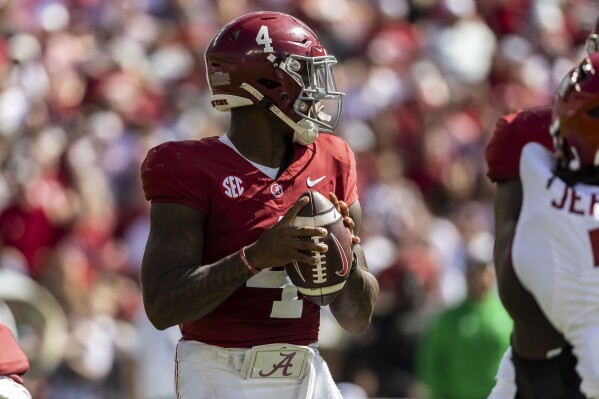 Alabama quarterback Jalen Milroe (4) looks for a passing outlet against Arkansas during the first half of an NCAA college football game, Saturday, Oct. 14, 2023, in Tuscaloosa, Ala. (AP Photo/Vasha Hunt)