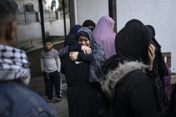 Palestinians mourn their relatives killed in the Israeli bombardment of the Gaza Strip, at the hospital Rafah, southern Gaza, Thursday, Dec. 14, 2023. (AP Photo/Fatima Shbair)
