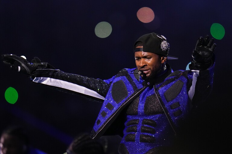Usher performs during halftime of the NFL Super Bowl 58 football game between the San Francisco 49ers and the Kansas City Chiefs on Sunday, February 11, 2024, in Las Vegas.  (AP Photo/Julio Cortez)