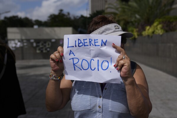 A protester holds a sign that reads in Spanish "Release Rocio!," referring to arrested activist Human Rights lawyer and activist Rocio San Miguel, on the sidelines of a press conference about her detention the previous week, outside office of the UN Development Program (PNUD) in Caracas, Venezuela, Wednesday, Feb 14, 2024. Rocio San Miguel is accused by the government of terrorism for allegedly plotting to kill President Nicolas Maduro. (APPhoto/Ariana Cubillos)