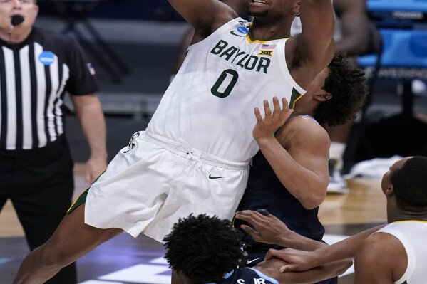 FILE - Baylor forward Flo Thamba (0) shoots against Villanova in the second half of a Sweet 16 game in the NCAA men's college basketball tournament at Hinkle Fieldhouse in Indianapolis, in this Saturday, March 27, 2021, file photo. All-American junior Jared Butler and his backcourt mates Davion Mitchell and MaCio Teague pretty much get all of the attention for the top-seeded Bears (26-2), who play a former Southwest Conference rival in the first national semifinal game Saturday. But those guards know they wouldn't be where they are now without the often interchangeable 245-pound post players _ the 6-foot-10 Thamba and and 6-8 Tchamwa Tchatchoua. (AP Photo/Michael Conroy, File)
