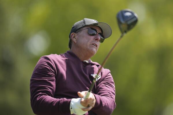 Phil Mickelson watches his tee shot on the fourth hole during a practice round for the PGA Championship golf tournament at Oak Hill Country Club on Wednesday, May 17, 2023, in Pittsford, N.Y. (AP Photo/Seth Wenig)