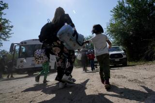 FILE - A migrant family from Venezuela walks to a Border Patrol transport vehicle after they and other migrants crossed the U.S.-Mexico border and turned themselves in June 16, 2021, in Del Rio, Texas. The Biden administration has agreed to accept up to 24,000 Venezuelan migrants, similar to how Ukrainians have been admitted after Russia’s invasion, while Mexico has agreed to accept some Venezuelans who are expelled from the United States, the two nations said Wednesday, Oct. 12, 2022. (AP Photo/Eric Gay, File)