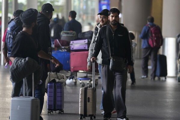 Indian passengers who travelled in an unmarked Legend Airlines A340 from Vatry Airport in France, arrive at the Chhatrapati Shivaji Maharaj International Airport in Mumbai, India, Tuesday, Dec. 26, 2023. A charter plane that was grounded in France for a human trafficking investigation arrived in India with 276 Indians aboard early Tuesday, authorities said. The passengers had been heading to Nicaragua but were instead blocked inside the Vatry Airport for four days in an exceptional holiday ordeal. (AP Photo/Rafiq Maqbool)