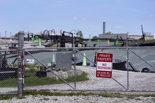 FILE - A no trespassing sign hangs on a fence around the West Lake Landfill Superfund site on Friday, April 21, 2023, in Bridgeton, Mo. The Senate has passed legislation that would compensate Americans exposed to radiation by the government by renewing a law initially passed more than three decades ago. The bill passed the Senate 69-30, with 20 Republicans and all but two Democrats voting in favor. But its prospects in the House are uncertain. (AP Photo/Jeff Roberson, File)