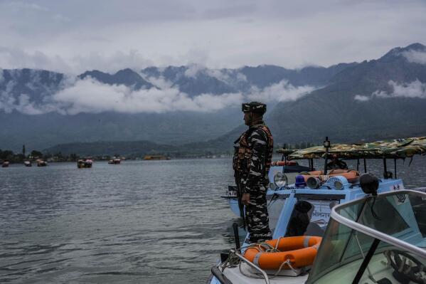 An Indian paramilitary soldier guards at the Dal Lake ahead of G20 tourism working group meeting in Srinagar Indian controlled Kashmir, Thursday, May 18, 2023. Indian authorities have stepped up security and deployed elite commandos to prevent rebel attacks during the meeting of officials from the Group of 20 industrialized and developing nations in the disputed region next week. (AP Photo/Mukhtar Khan)