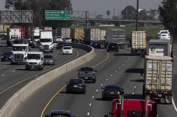 Vehicles move along the 710 highway near the Ports of Los Angeles and Long Beach, Monday, March 10, 2025, in Long Beach, Calif. (AP Photo/Etienne Laurent, File)