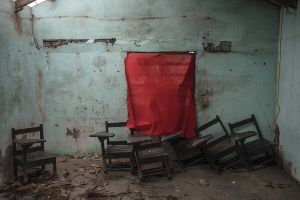 A red cloth serves as a curtain for a school window in a classroom damaged by flooding driven by a Gulf of Mexico sea-level rise, in El Bosque, in the state of Tabasco, Mexico, Wednesday, Nov. 29, 2023. (AP Photo/Felix Marquez)