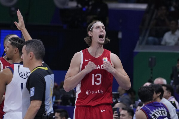 Canada forward Kelly Olynyk (13) reacts after a missed shot during the Basketball World Cup bronze medal game between the United States and Canada in Manila, Philippines, Sunday, Sept. 10, 2023. (AP Photo/Michael Conroy)