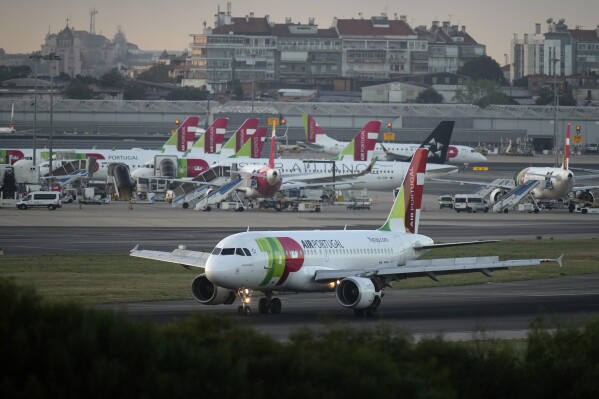 A TAP Air Portugal Airbus A310 lands in Lisbon at sunrise, Thursday, Sept. 28, 2023. Portugal's government is expected to announce Thursday that it is having another stab at privatizing flag carrier TAP Air Portugal. (AP Photo/Armando Franca)