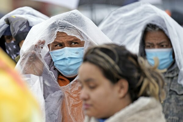 FILE - In this Feb. 17, 2021, file photo, Juan Guerrlo, center left, waits in line to fill his propane tanks in Houston. Customers had to wait over an hour in the freezing rain to fill their tanks. (AP Photo/David J. Phillip, File)