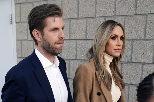 Eric Trump, left, son of President Donald Trump and wife Lara Trump depart after a news conference on legal challenges to vote counting in Pennsylvania, Wednesday, Nov. 4, 2020, in Philadelphia. (AP Photo/Matt Slocum)