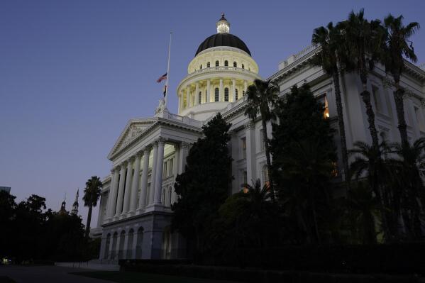 FILE - The lights of the Capitol dome shine as lawmakers work into the night in Sacramento, Calif., Friday, Sept. 10, 2021. Social media users are misrepresenting a California bill that would allow non-citizens authorized to work in the U.S. to become police officers. (AP Photo/Rich Pedroncelli, File)