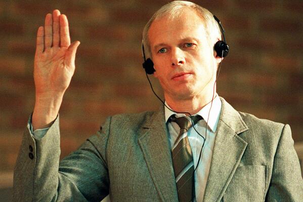 FILE - Polish citizen Janusz Walus is sworn in during a Truth and Reconciliation Commission hearing in Mamelodi, Pretoria, South Africa, Nov. 24, 1997. South Africa’s Constitutional Court on Monday Nov. 21, 2022, ordered the release of Janusz Walus, the man jailed for killing anti-apartheid leader Chris Hani in 1993. Hani was killed outside his home in Boksburg, east of Johannesburg, in an assassination that threatened to plunge South Africa into political violence ahead of its transition from white minority rule to democracy. (AP Photo/Cobus Bodenstein, File)