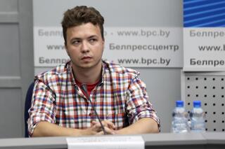 FILE In this file photo taken on Monday, June 14, 2021, Belarusian dissident journalist Raman Pratasevich attends a news conference at the National Press Center of Ministry of Foreign Affairs in Minsk, Belarus. The dissident Belarusian journalist and his Russian girlfriend who were arrested after their airline flight was diverted to Minsk last month have been moved from jail to house arrest. Raman Pratasevich, who ran a messaging app channel that was widely used in last year’s massive protests against President Alexander Lukashenko, and his Russian girlfriend Sofia Sapega were seized on May 23 when their flight from Greece to Lithuania was diverted to Minsk. (Ramil Nasibulin/BelTA pool photo via AP, File)