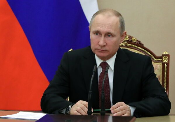 
              In this Jan. 26, 2018, photo, Russian President Vladimir Putin chairs a Security Council meeting in Moscow, Russia. The State Department has notified Congress that it will not impose new sanctions on Russia at this time. The State Department says it is confident that new legislation enacted last year is significantly deterring Russian defense sales. (Mikhail Klimentyev, Sputnik, Kremlin Pool Photo via AP)
            