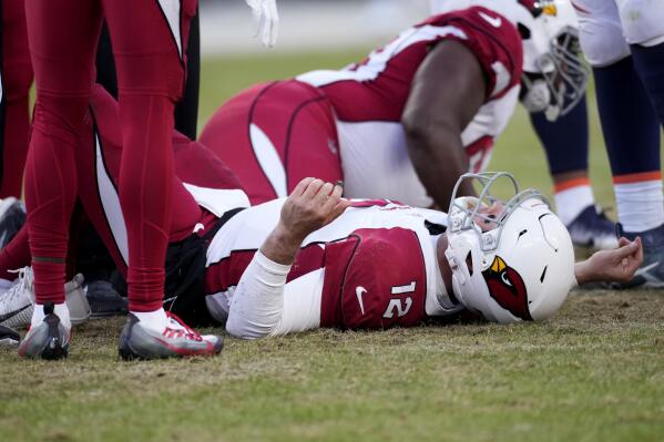Arizona Cardinals quarterback Colt McCoy (12) lies on the turf after an injury against the Denver Broncos during the second half of an NFL football game, Sunday, Dec. 18, 2022, in Denver. (AP Photo/David Zalubowski)
