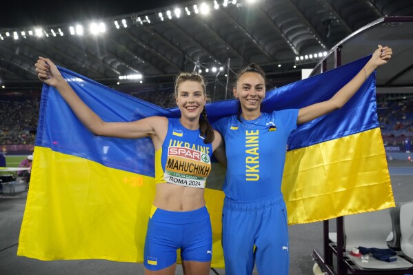Gold medalist Yaroslava Mahuchikh, left, and bronze medalist Iryna Gerashchenko, both of Ukraine, pose after the women's high jump final at the the European Athletics Championships in Rome, Sunday, June 9, 2024. (AP Photo/Andrew Medichini)