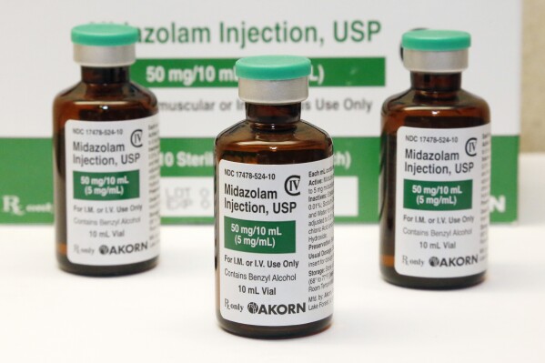 FILE - This July 25, 2014 photo shows vials of the sedative midazolam at a hospital pharmacy in Oklahoma City. An investigation led by The Associated Press published in 2024, has found the practice of giving sedatives to people detained by police spread quietly over the last 15 years, built on questionable science and backed by police-aligned experts. (AP Photo/File)