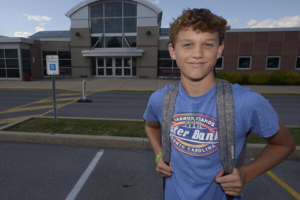 Braylon Price, 13, pauses on his way home from Bellefonte Middle School Wednesday, Aug. 31, 2022, in Bellefonte, Pa. The teenager was among more than 45,000 Pennsylvania students whose parents elected to take advantage of a new state pandemic-era law option of holding their child back a year in school. He repeated the sixth grade. (AP Photo/Gary M. Baranec)