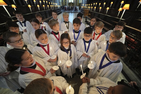 The Choristers of St Paul's choir, including girls for first time in 900-year history, rehearse for the Christmas services in St Paul's Cathedral, in London, Monday, Dec. 23 2024. (AP Photo/Kin Cheung)