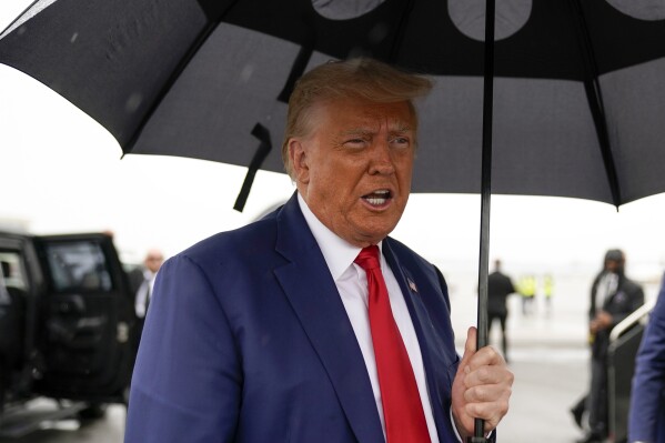 FILE - Former President Donald Trump speaks before he boards his plane at Ronald Reagan Washington National Airport, Aug. 3, 2023, in Arlington, Va. Special counsel Jack Smith’s team obtained a search warrant in January for records related to former President Donald Trump’s Twitter account, and a judge levied a $350,000 fine on the company for missing the deadline to company. That’s according to court documents released Wednesday. (AP Photo/Alex Brandon, File)