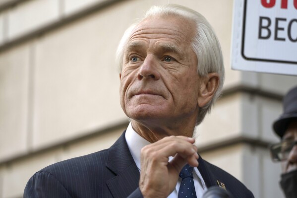 FILE - Former White House trade adviser Peter Navarro speaks to the media as he departs federal court, Tuesday, Sept. 5, 2023, in Washington. Navarro was convicted Thursday, Sept. 7, of contempt of Congress charges filed after he was accused of refusing to cooperate with a congressional investigation into the Jan. 6, 2021, attack on the U.S. Capitol. (AP Photo/Mark Schiefelbein, File)