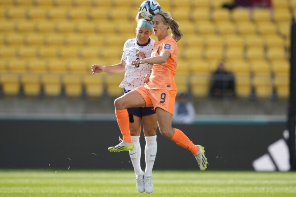 United States' Julie Ertz, left, and Netherlands' Katja Snoeijs jump for a header during the first half of the FIFA Women's World Cup Group E soccer match between the United States and the Netherlands in Wellington, New Zealand, Thursday, July 27, 2023. (AP Photo/John Cowpland)
