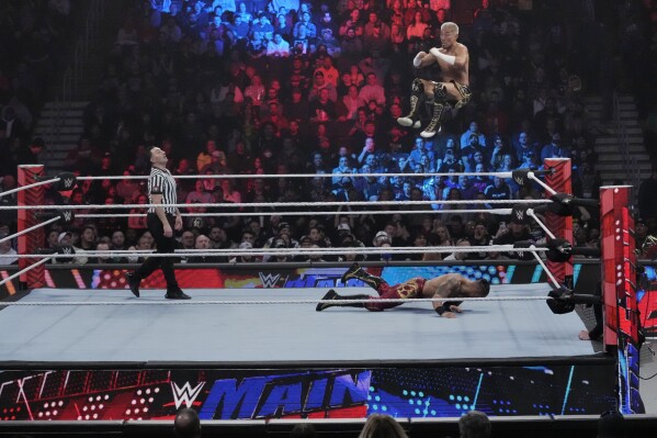 Wrestler Akira Tozawa goes airborne during his match with Carmelo Hayes during the WWE Monday Night RAW event, Monday, March 6, 2023, in Boston. WWE’s popular television show, “Friday Night Smackdown,” will be moving from Fox to USA Network next year under a new five-year domestic media rights partnership with NBCUniversal, Thursday, Sept. 21, 2023. “Smackdown” will begin airing on USA Network in October 2024.(AP Photo/Charles Krupa)